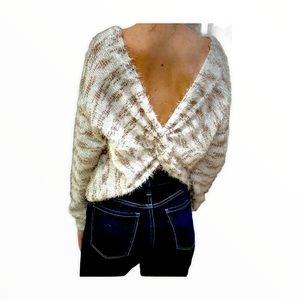 A cute peek a boo back sweater in taupe.